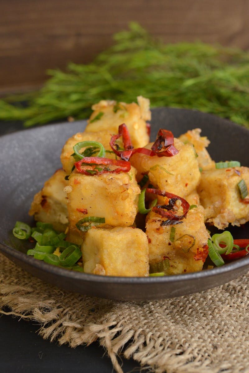 Delicious fried tofu cubes garnished with chili and green onions, served in Sydney.