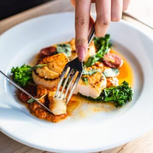 stainless steel fork on white ceramic plate